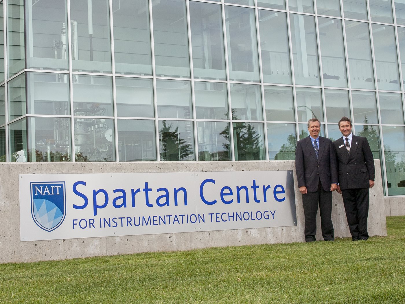 Mike Begin and Sam Shaw stand in from of the Spartan Centre for Instrumentation Technology on NAIT's campus in 2007