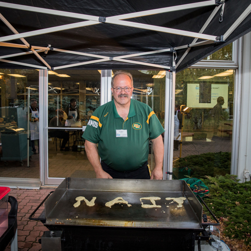 : Former Instructor and NAIT Academic Staff Association president Garry Wilson volunteers by flipping pancakes at NAIT it Forward, the annual staff-run fundraising campaign