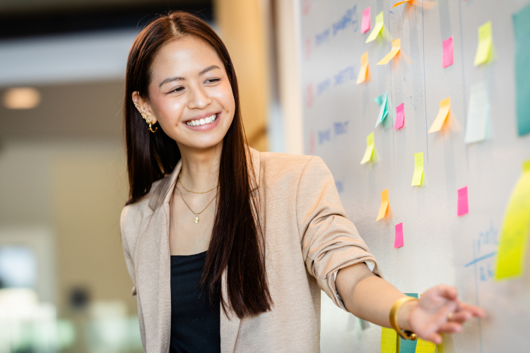 leadership student pointing at a whiteboard during presentation