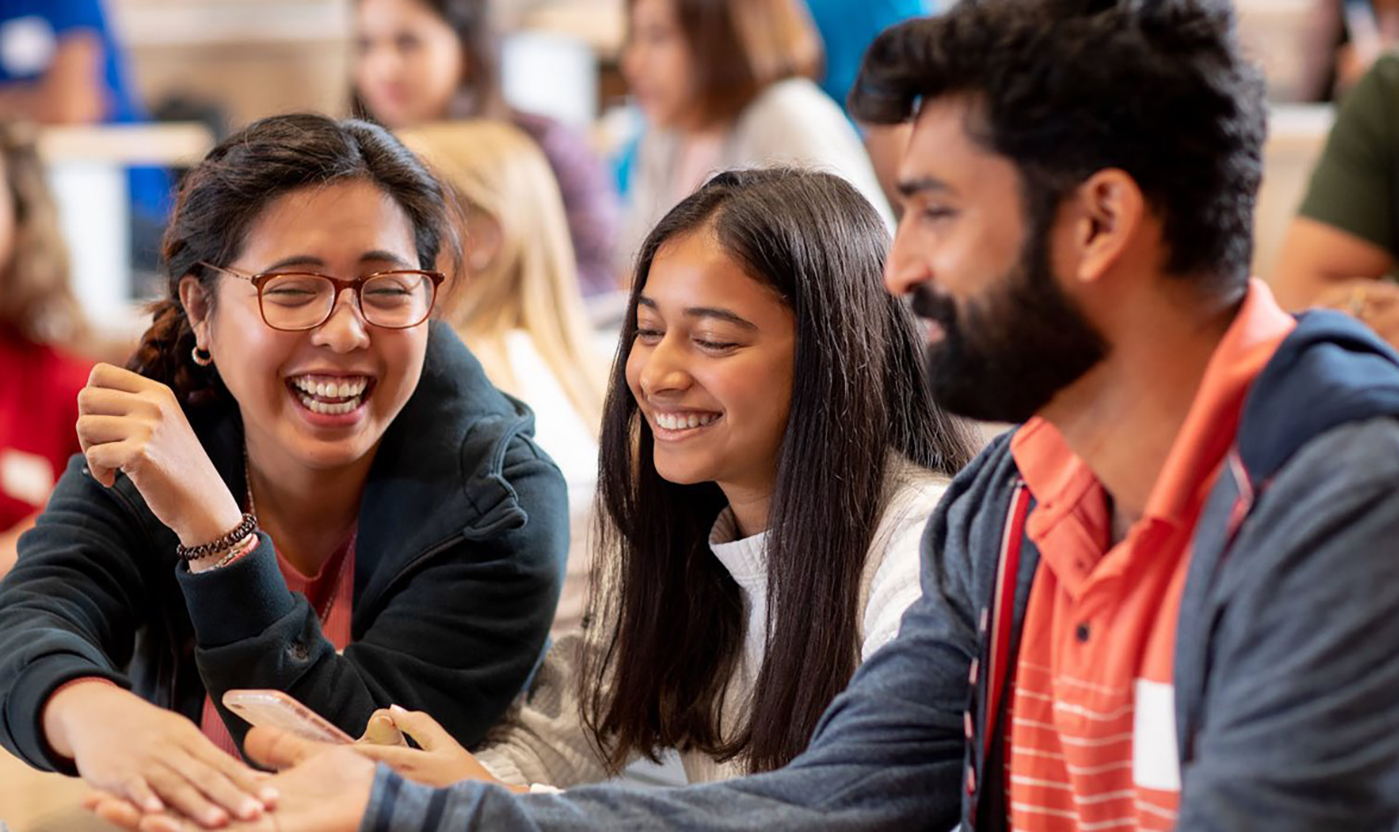 3 NAIT students laughing and working together