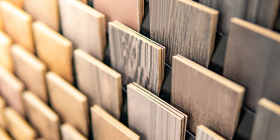 Long boards of sample flooring arranged vertically.