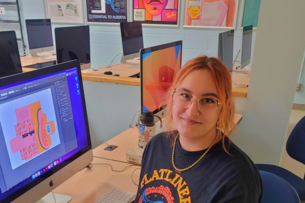 Student a desk in graphic communications lab