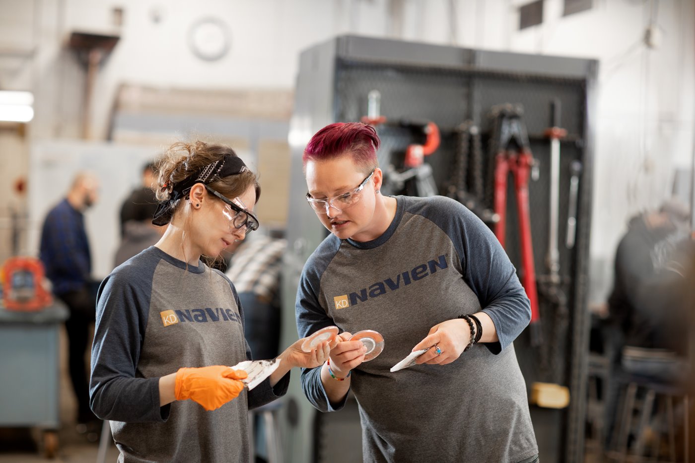 Two plumbers analyze test strips