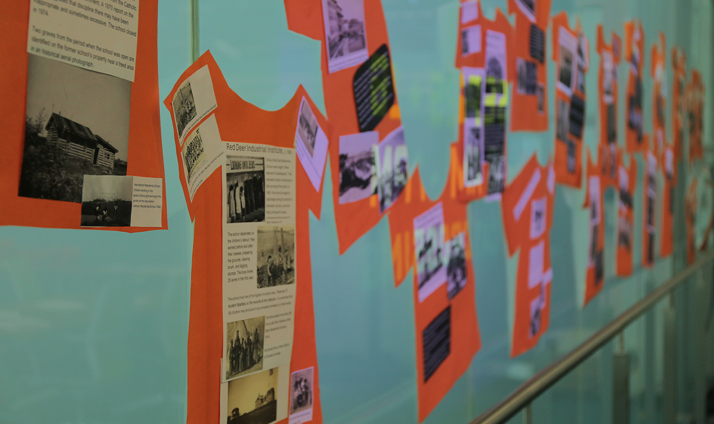 Artwork showing photos  on orange shirts on NAIT wall