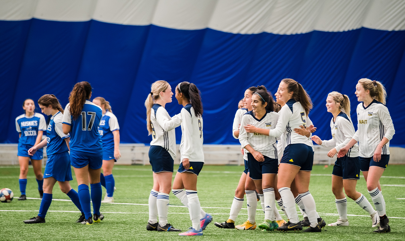 Sarah Moorji and the other women on the Ooks soccer team celebrating a goal