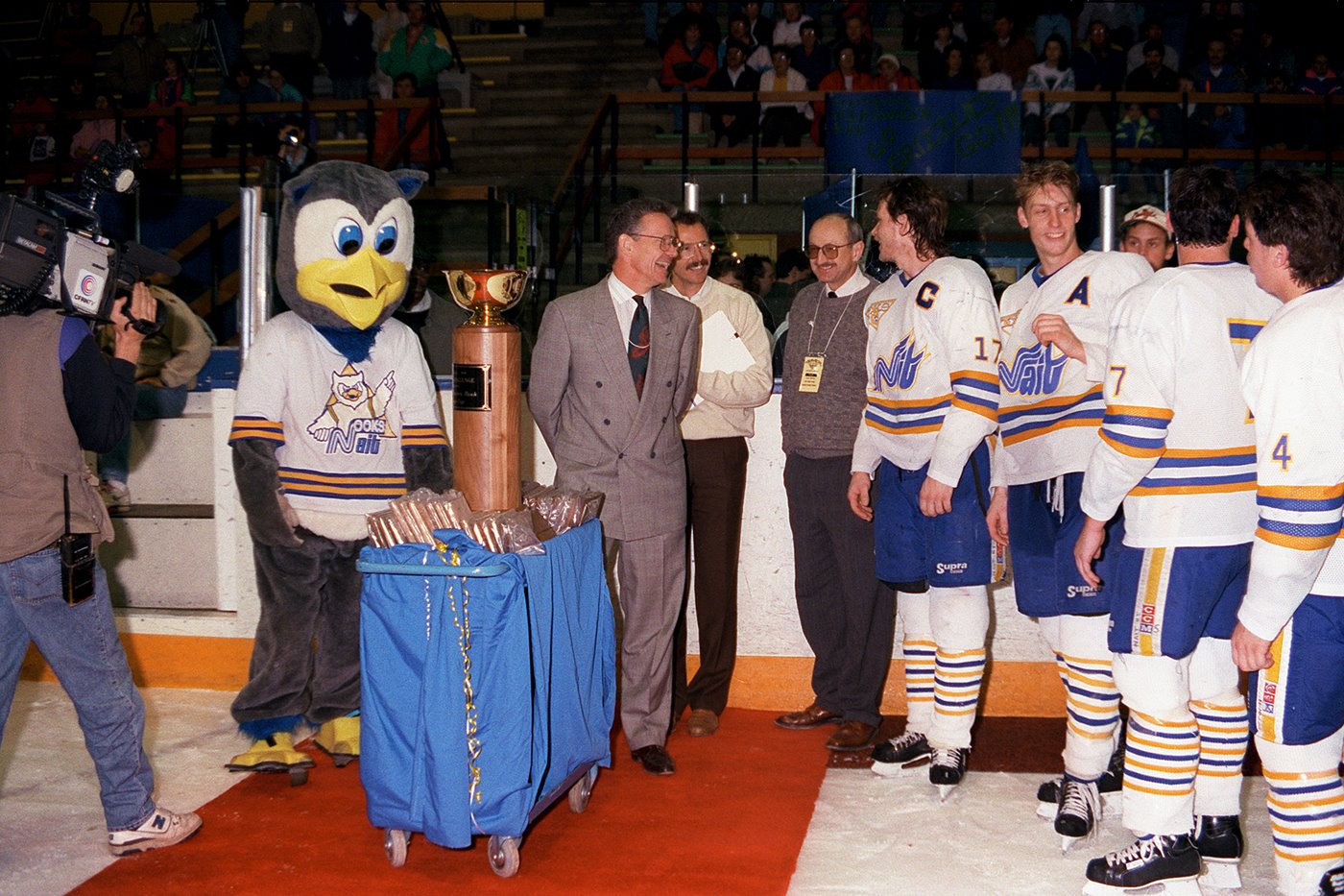 Ooks hockey team in the 90s getting their trophy on the ice