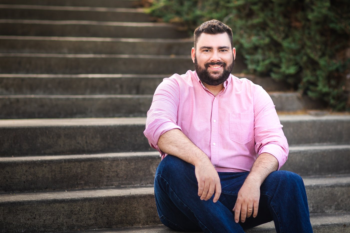 NAIT alumni international student sitting on stairs